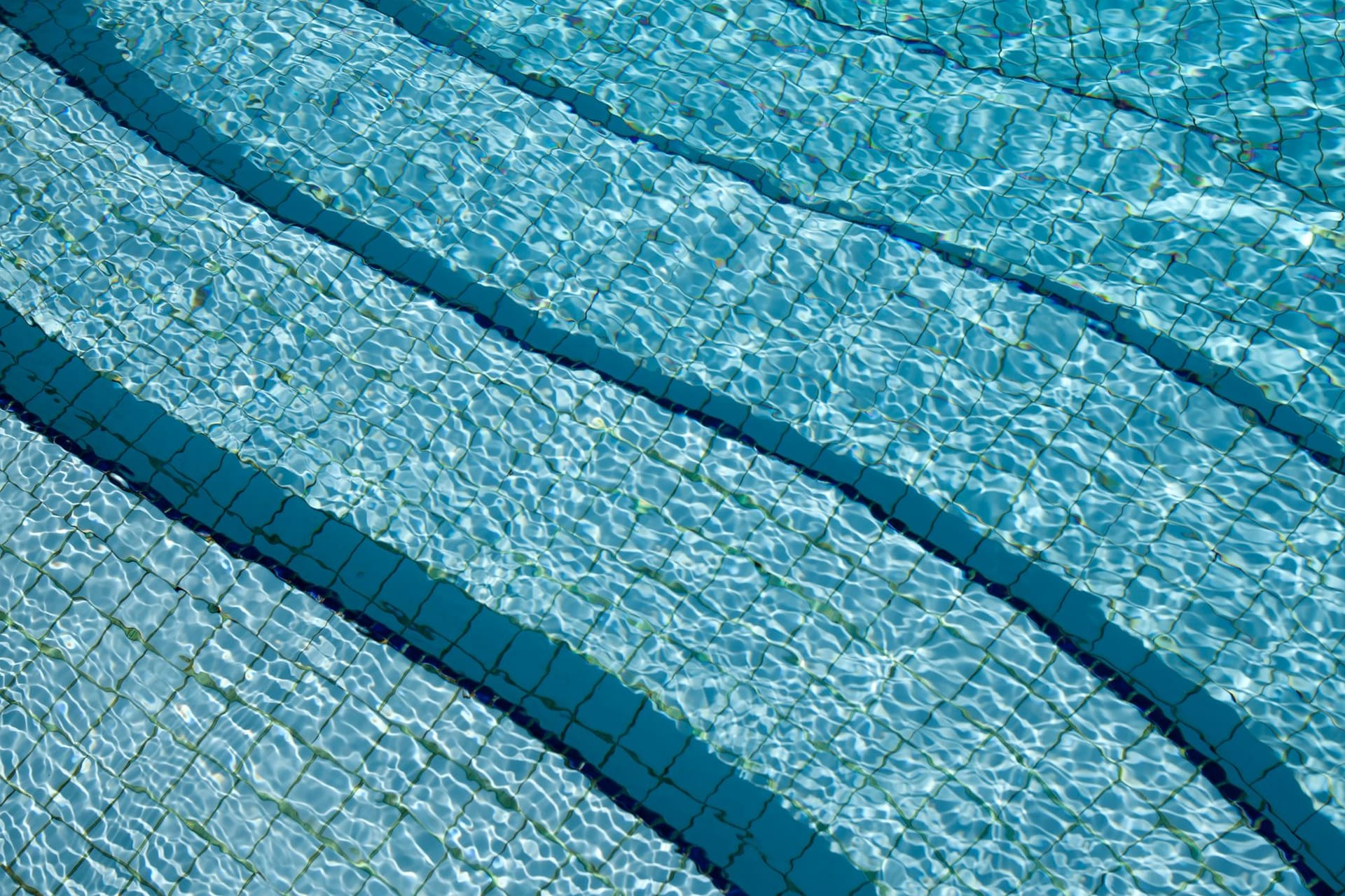 Clear pool water rippling over a tiled pool floor